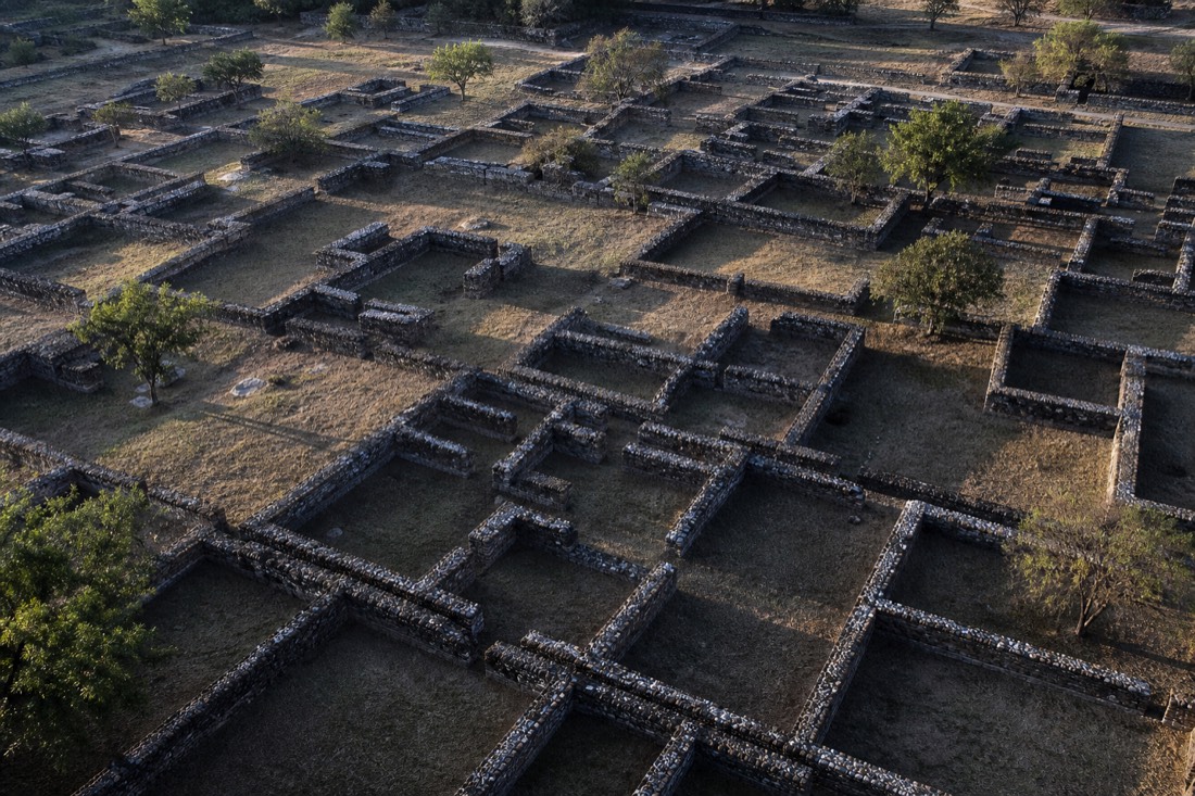An aerial view of excavated residential compound walls in a strict grid