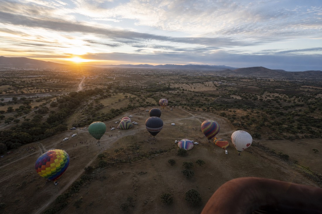Looking down from a rising hot air balloon in its first minutes of ascent